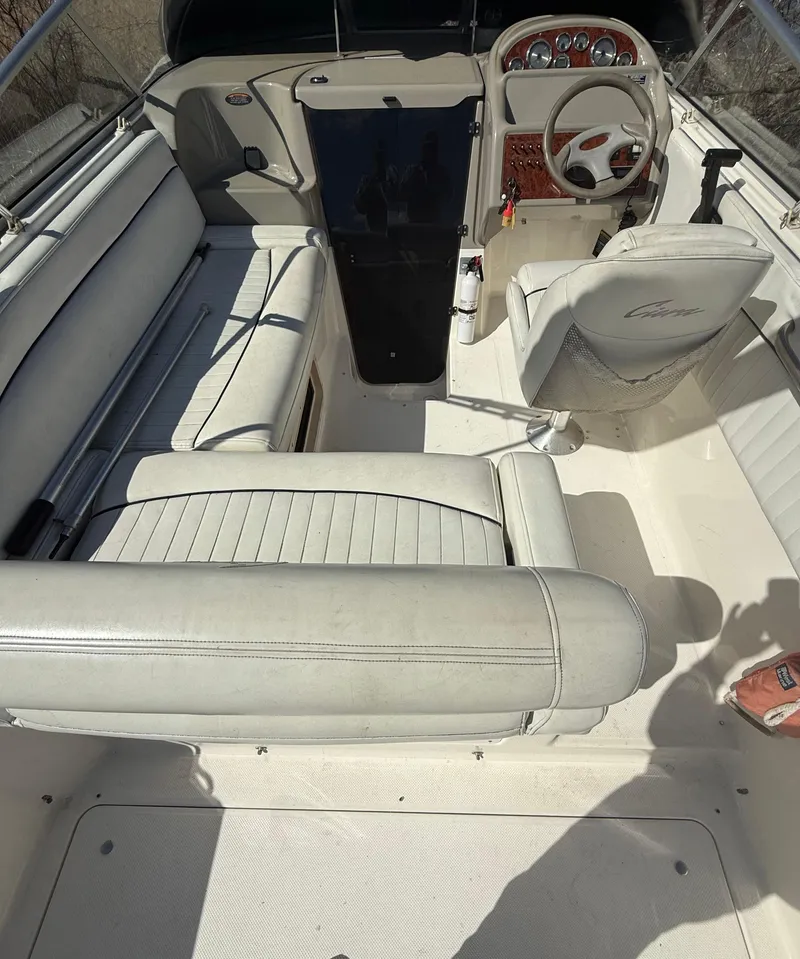 Slide: The Image of 1997 Bayliner 2655 Ciera Sunbridge interior with white seating and steering console. - 16