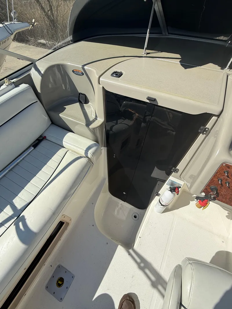 Slide: The Image of 1997 Bayliner 2655 Ciera Sunbridge interior with white seating and cabin entrance. - 18