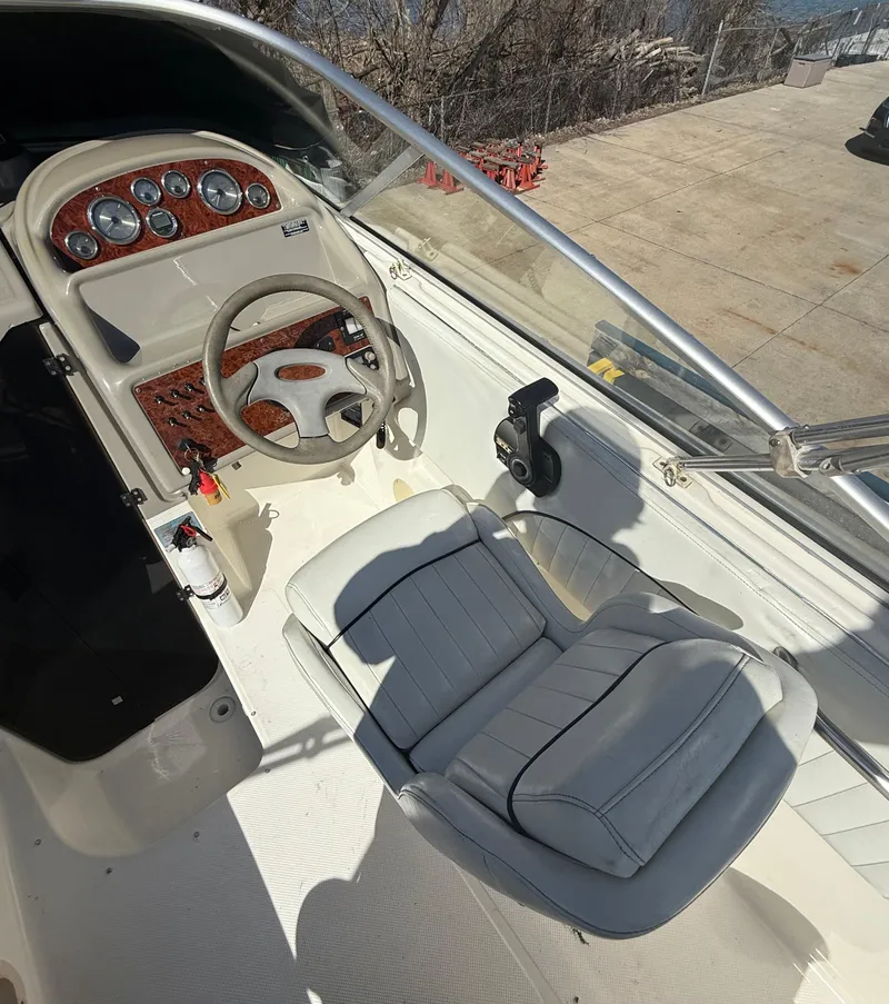 Slide: The Image of 1997 Bayliner 2655 Ciera Sunbridge cockpit with steering wheel and seating. - 19