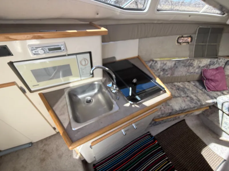 Slide: The Image of Interior of 1997 Bayliner 2655 Ciera Sunbridge with kitchenette and seating area. - 30