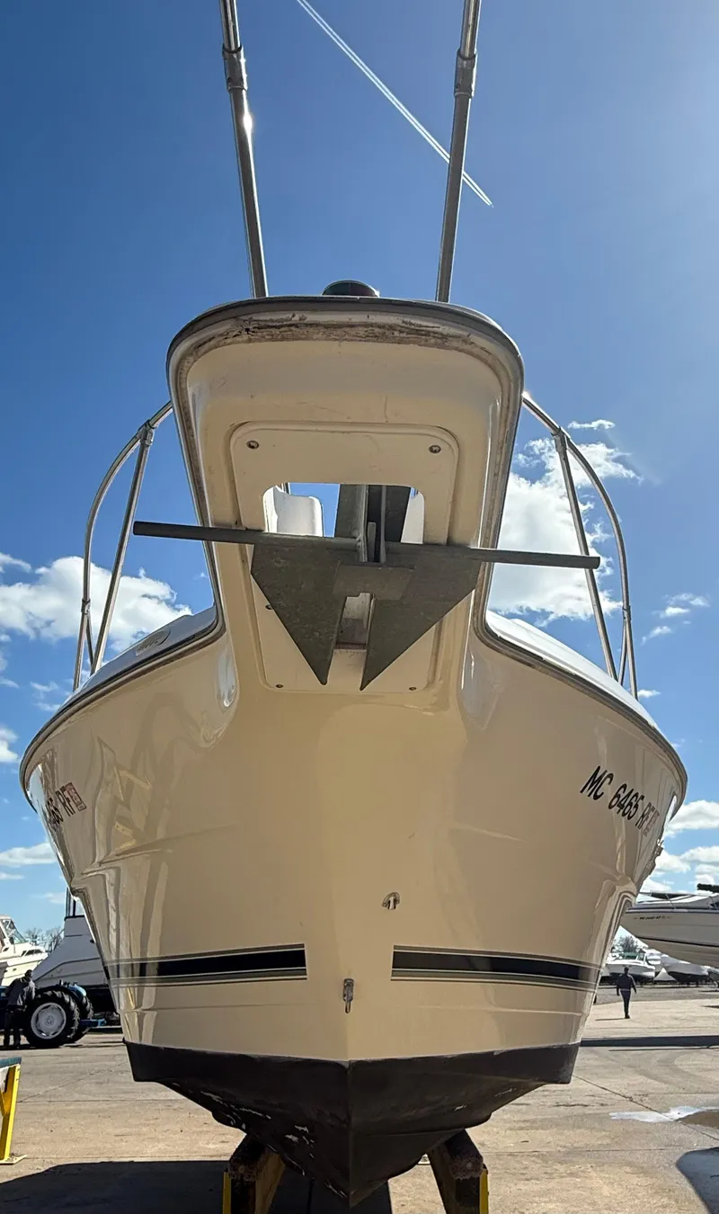 Slide: The Image of 1997 Bayliner 2655 Ciera Sunbridge boat, docked under a clear blue sky. - 4