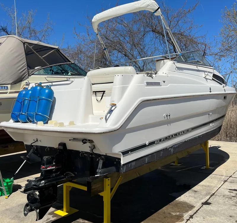 Slide: The Image of 1997 Bayliner 2655 Ciera Sunbridge boat on dry dock, white exterior, sunny day. - 6