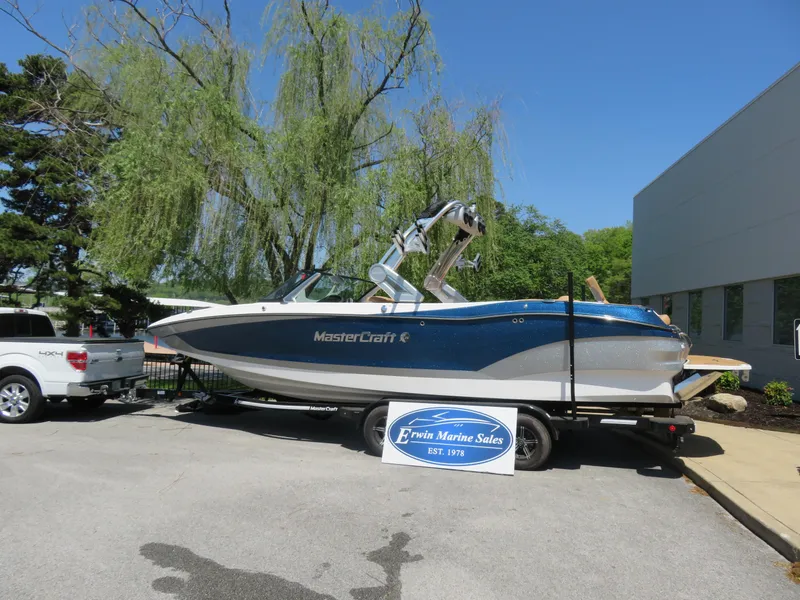 Slide: The Image of 2023 MasterCraft X26 boat on trailer at Erwin Marine Sales dealership. - 1