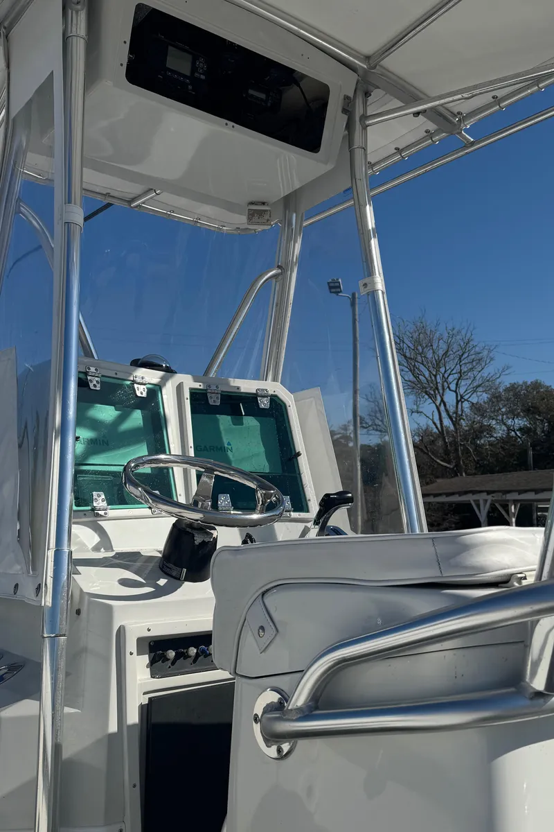 Slide: The Image of 2001 Contender 23 Open boat interior with steering wheel and control panel. - 11