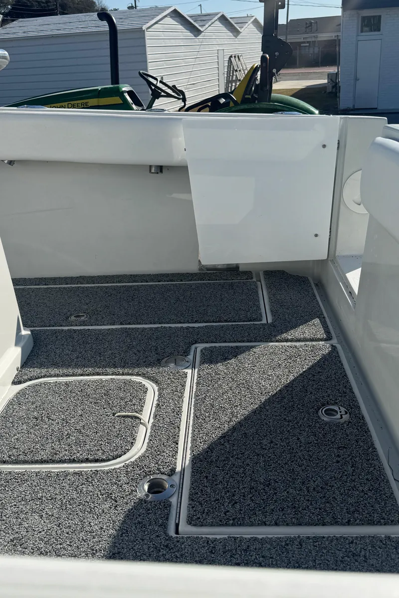 Slide: The Image of 2001 Contender 23 Open boat interior with textured flooring and storage compartments. - 12