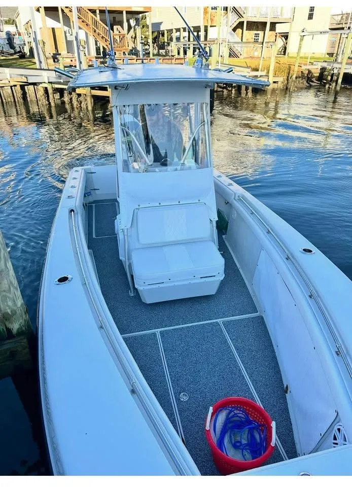 Slide: The Image of 2001 Contender 23 Open boat docked, featuring spacious deck and seating. - 17