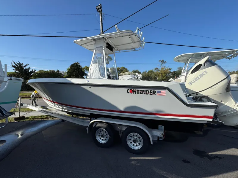 Slide: The Image of 2001 Contender 23 Open boat on trailer, side view, with Suzuki outboard motor. - 3