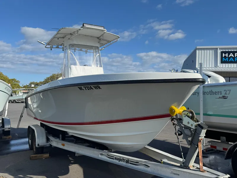 Slide: The Image of 2001 Contender 23 Open boat on trailer, parked outdoors under a blue sky. - 6