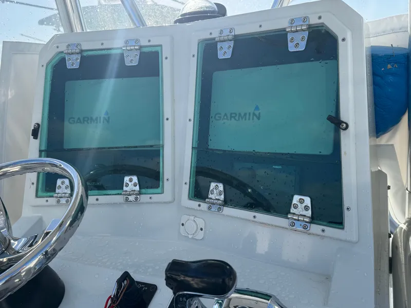 Slide: The Image of Console of 2001 Contender 23 Open boat with Garmin displays and steering wheel. - 7