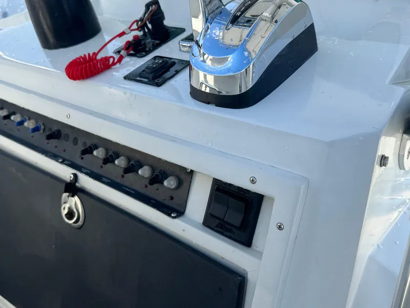 Slide: The Image of Control panel of a 2001 Contender 23 Open boat with throttle and switches. - 8