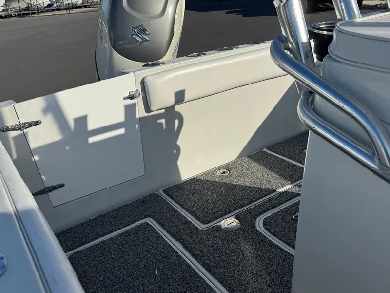 Slide: The Image of 2001 Contender 23 Open boat interior with gray flooring and stainless steel railing. - 9