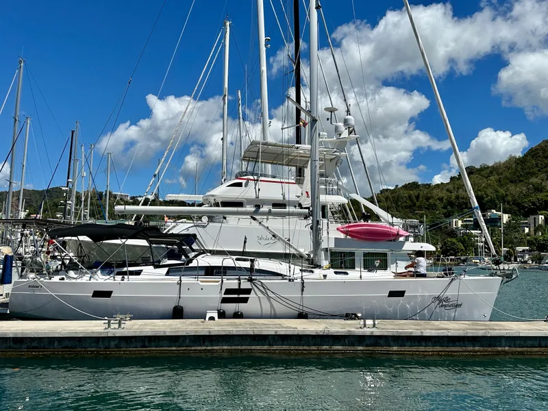 Slide: The Image of 2022 Elan Impression 50.1 yacht docked at marina under clear blue sky. - 1