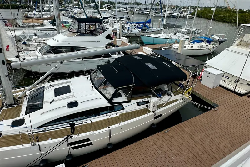Slide: The Image of 2022 Elan Impression 50.1 yacht docked at marina with other boats. - 10