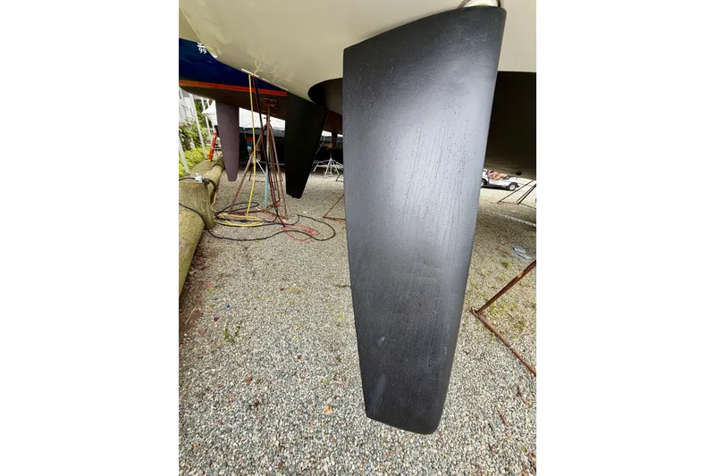Slide: The Image of Elan Impression 50.1 2022 yacht keel on gravel, under maintenance. - 107