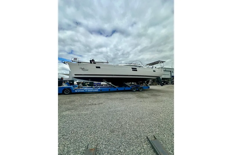 Slide: The Image of 2022 Elan Impression 50.1 yacht on trailer at Mystic Shipyard under cloudy sky. - 111