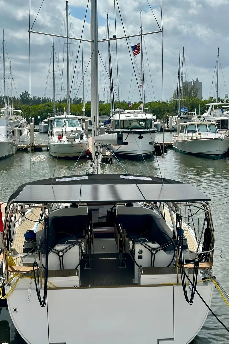 Slide: The Image of 2022 Elan Impression 50.1 yacht docked at a marina with other boats. - 13