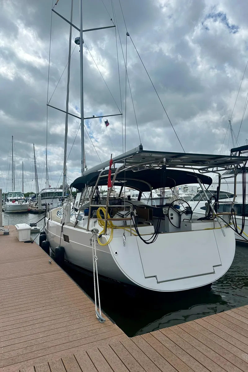 Slide: The Image of 2022 Elan Impression 50.1 yacht docked at marina under cloudy sky. - 15