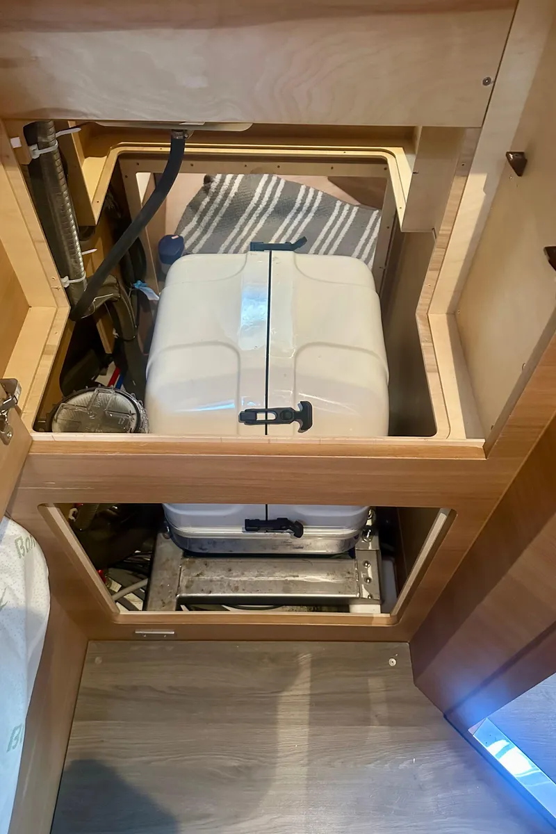 Slide: The Image of Elan Impression 50.1 2022 yacht interior showing storage compartment with equipment. - 17