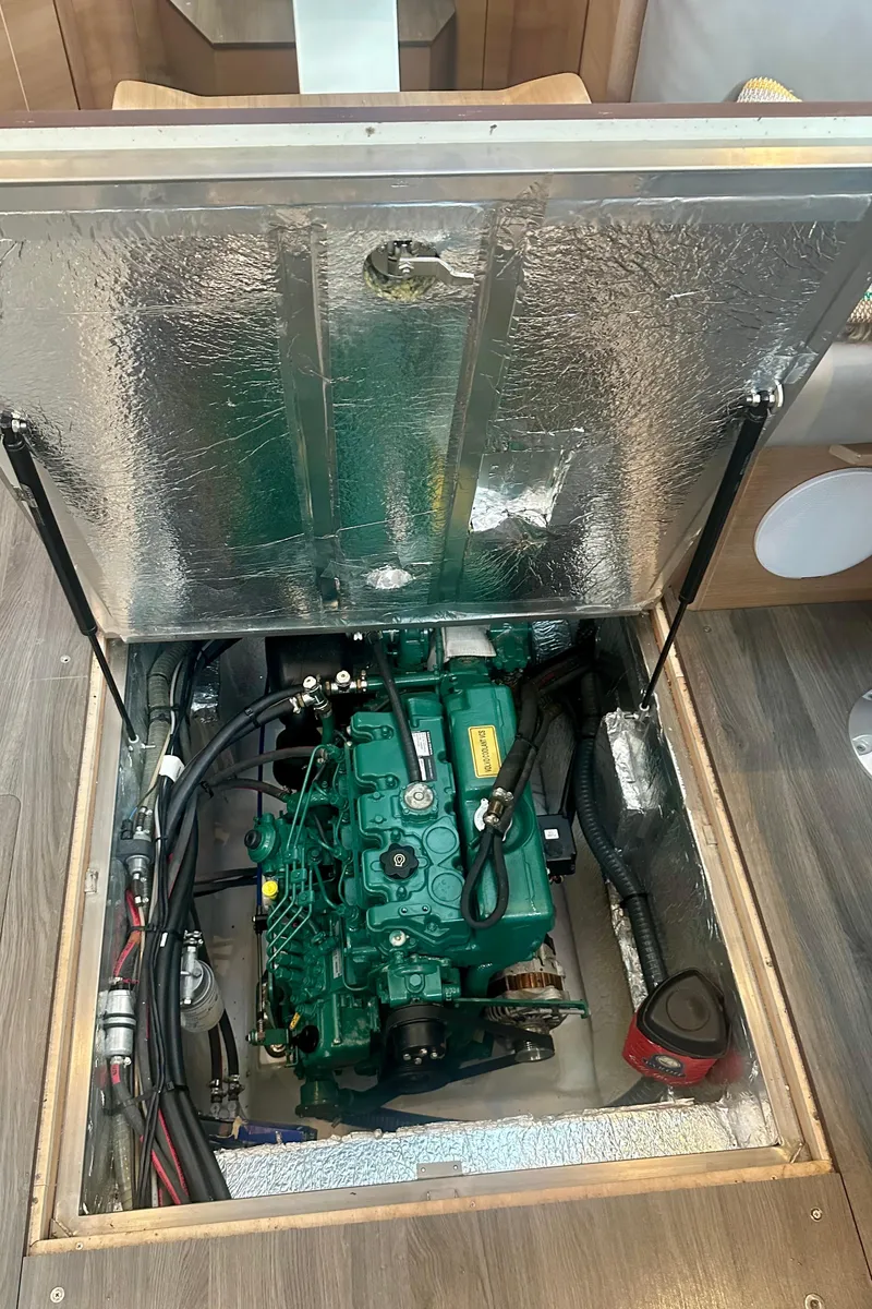 Slide: The Image of Engine compartment of a 2022 Elan Impression 50.1 sailboat, showcasing the engine and surrounding components. - 18