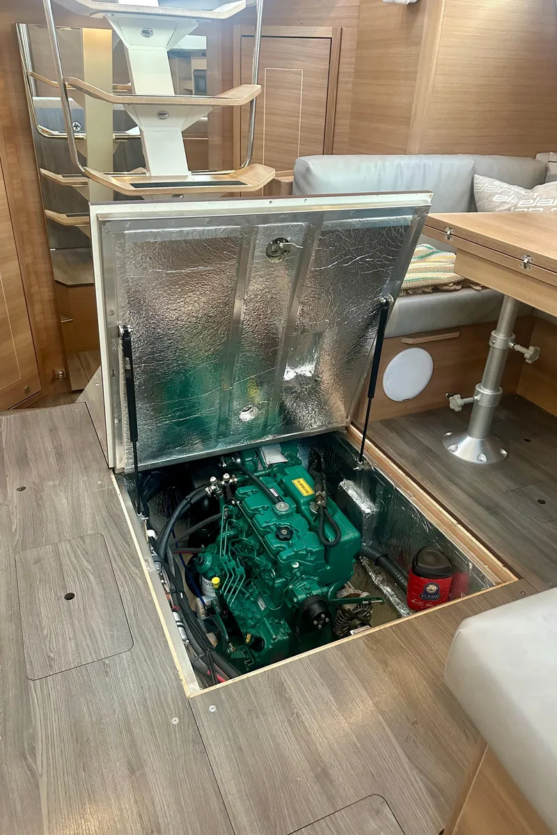 Slide: The Image of Engine compartment of 2022 Elan Impression 50.1 yacht, featuring a green engine. - 19