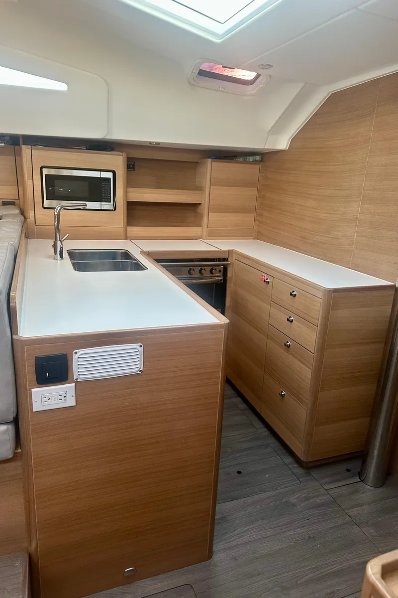 Slide: The Image of Modern kitchen interior of 2022 Elan Impression 50.1 yacht with wood finish. - 22