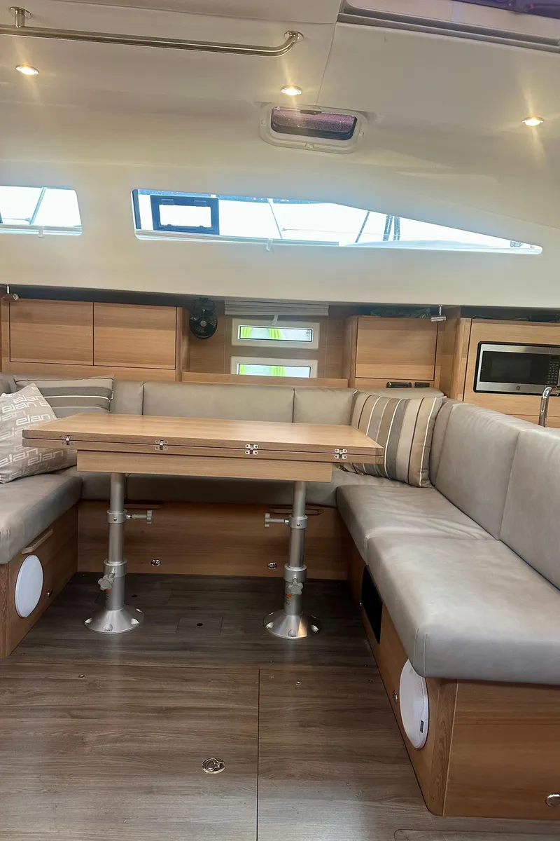 Slide: The Image of 2022 Elan Impression 50.1 yacht interior with modern seating and wooden table. - 23