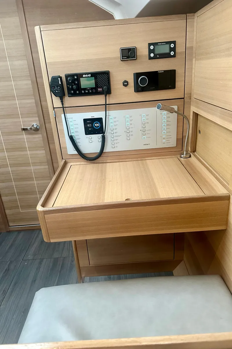 Slide: The Image of 2022 Elan Impression 50.1 yacht interior with navigation equipment and wooden desk. - 24