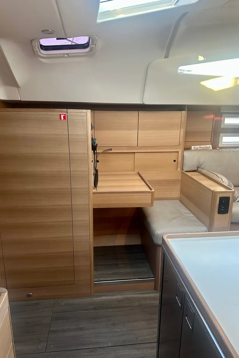 Slide: The Image of 2022 Elan Impression 50.1 yacht interior with modern wood finish and seating area. - 27