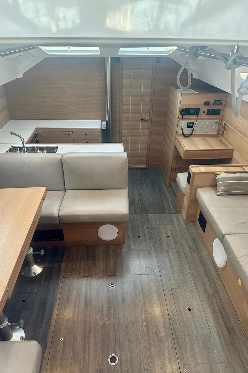 Slide: The Image of Interior of 2022 Elan Impression 50.1 yacht, featuring modern seating and wooden finishes. - 28