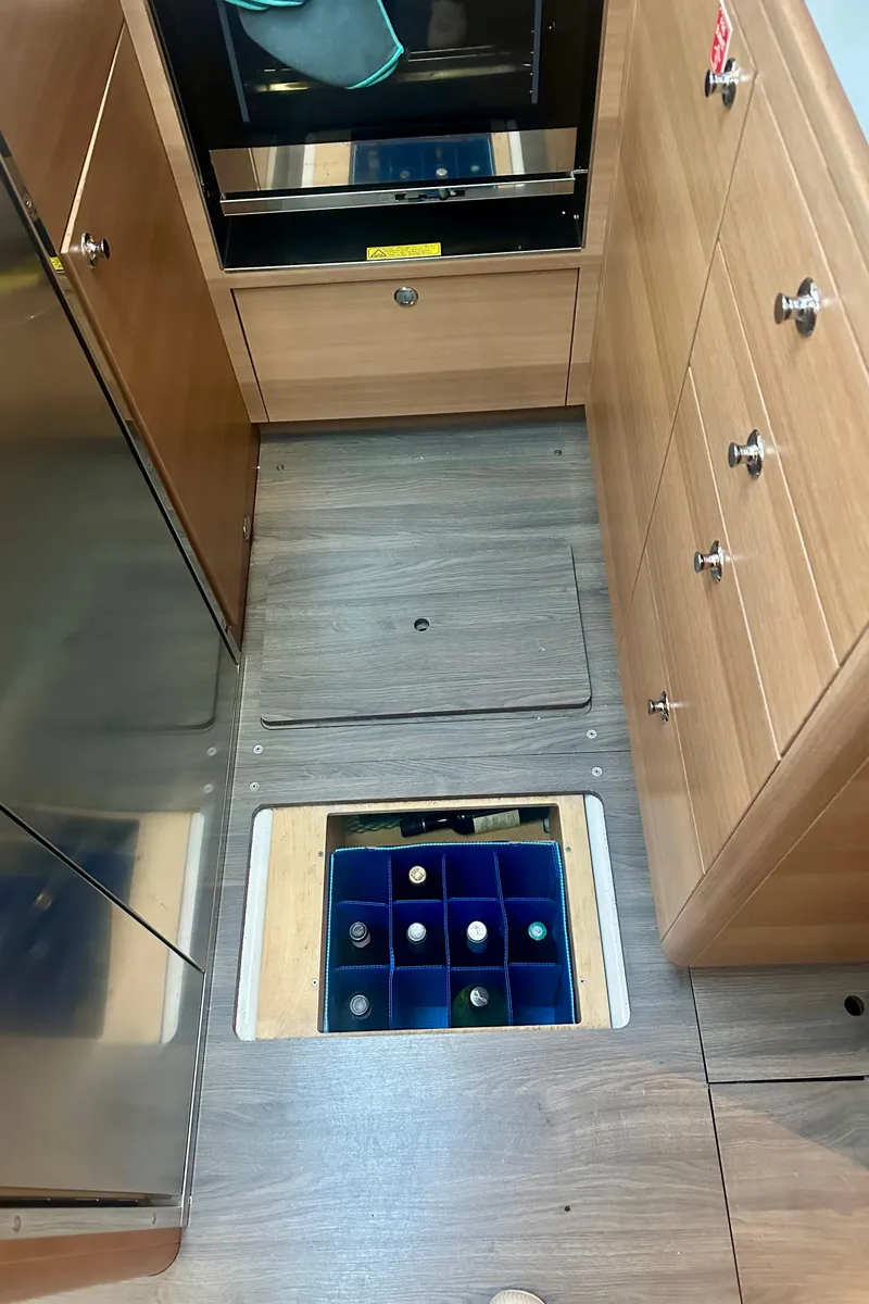 Slide: The Image of 2022 Elan Impression 50.1 yacht interior with floor storage for wine bottles. - 30