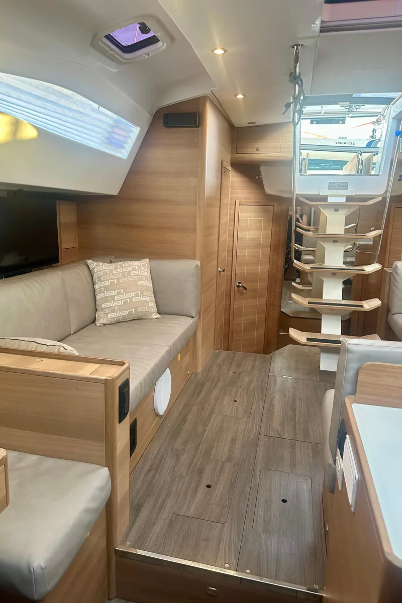 Slide: The Image of Interior of 2022 Elan Impression 50.1 yacht, featuring modern wood finishes and comfortable seating. - 31