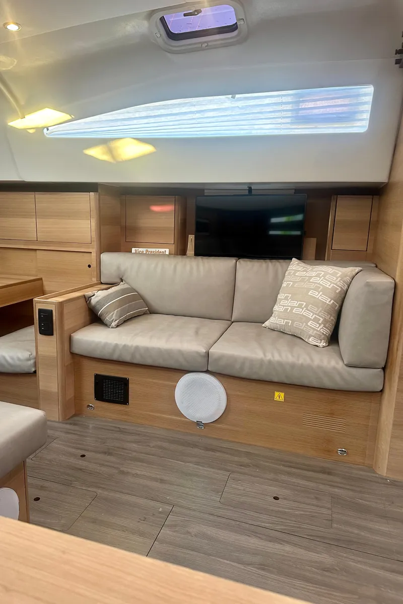 Slide: The Image of 2022 Elan Impression 50.1 yacht interior with modern seating and wooden accents. - 33