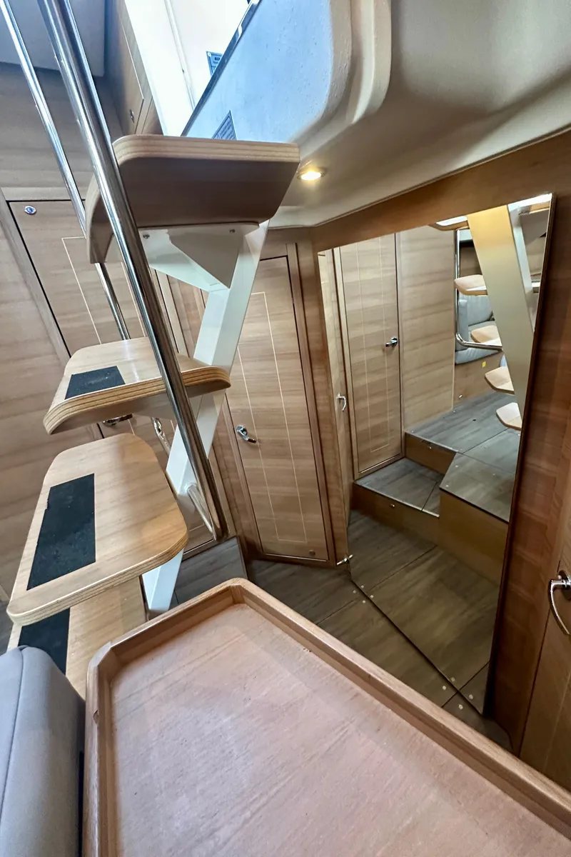 Slide: The Image of Interior of 2022 Elan Impression 50.1 yacht, featuring modern wooden design and sleek staircase. - 41