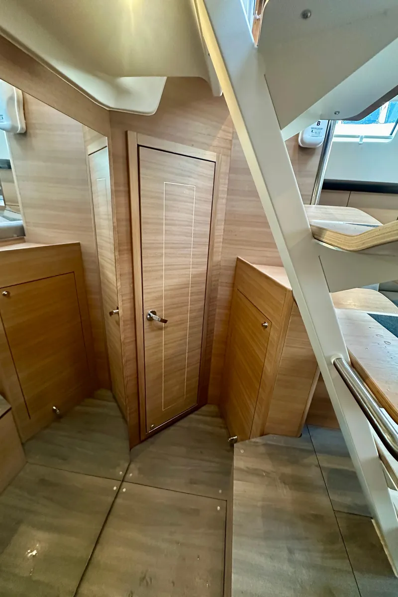 Slide: The Image of 2022 Elan Impression 50.1 yacht interior with wooden finishes and staircase. - 42