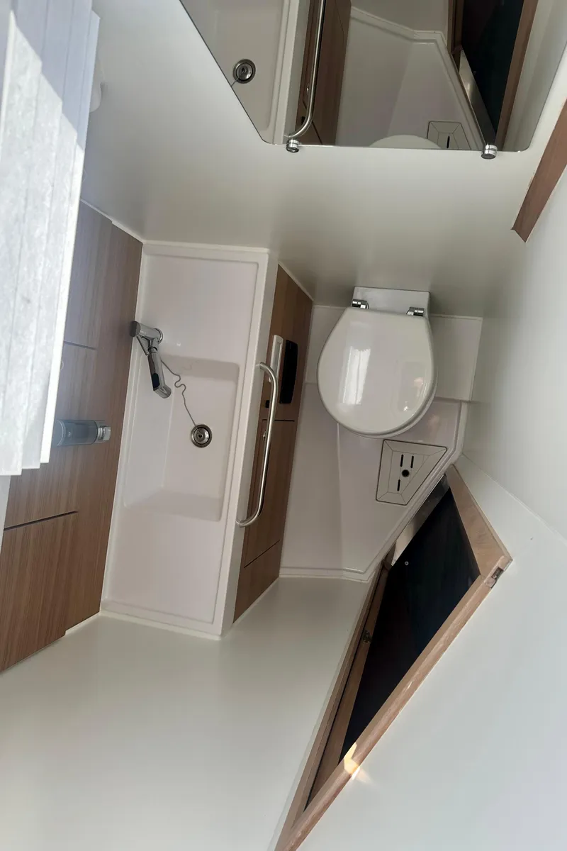 Slide: The Image of 2022 Elan Impression 50.1 yacht bathroom with modern fixtures and wooden accents. - 45