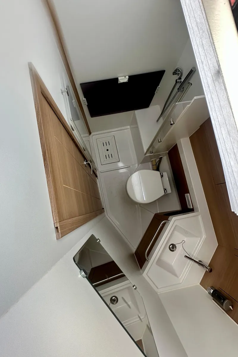 Slide: The Image of 2022 Elan Impression 50.1 yacht bathroom with modern fixtures and wooden accents. - 46