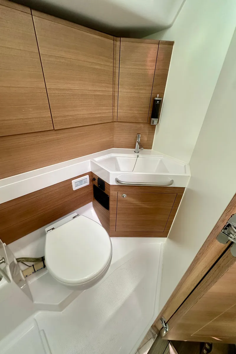 Slide: The Image of 2022 Elan Impression 50.1 yacht bathroom with modern wood cabinetry and compact design. - 47