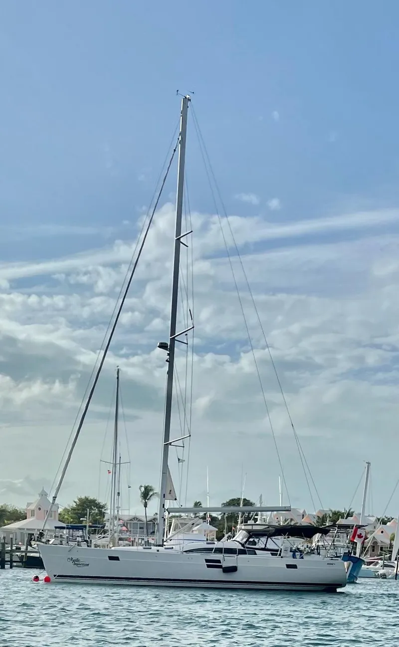 Slide: The Image of 2022 Elan Impression 50.1 sailboat on calm water under a clear sky. - 5