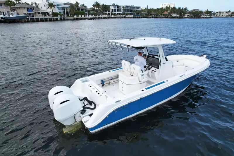 Slide: The Image of 2023 Edgewater 262CC boat on water, featuring dual engines and sleek design. - 4