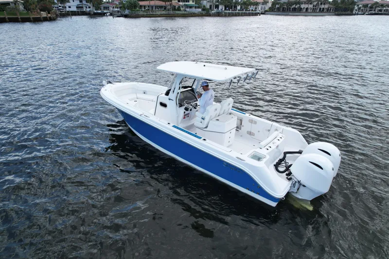 Slide: The Image of 2023 Edgewater 262CC boat on water, featuring dual engines and sleek design. - 6