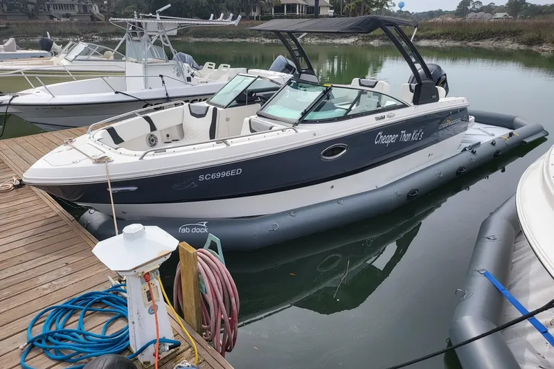 Slide: The Image of ```plaintext 2025 Center Console Eco dry dock boat moored at a dock with inflatable support. ``` - 12