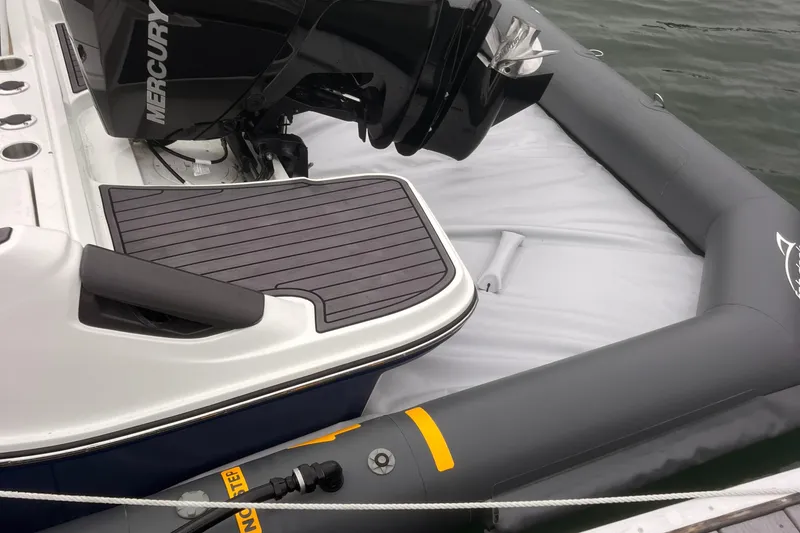 Slide: The Image of Center Console Eco dry dock 2025 with Mercury engine, docked on water. - 7