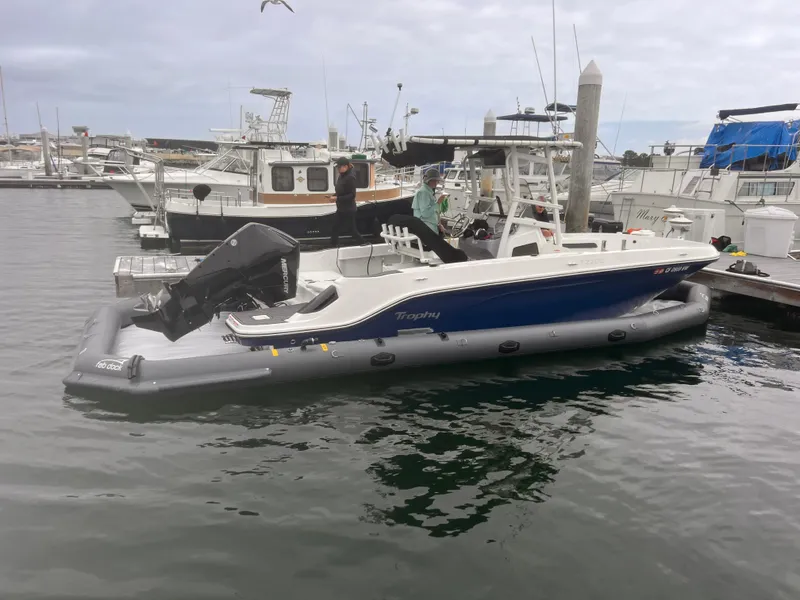 Slide: The Image of 2025 Center Console Eco Dry Dock boat moored at marina, featuring sleek design and modern amenities. - 2