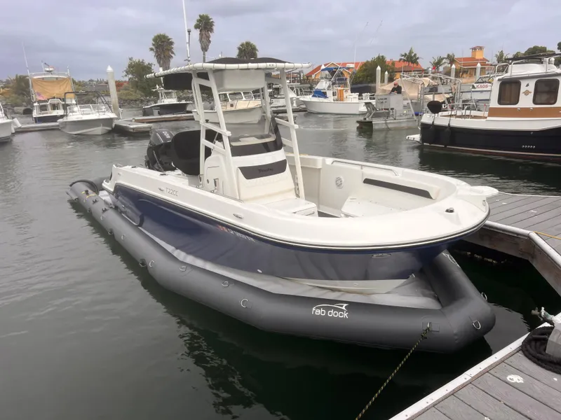 Slide: The Image of Center Console Eco dry dock 2025 boat moored at marina with inflatable dock. - 4