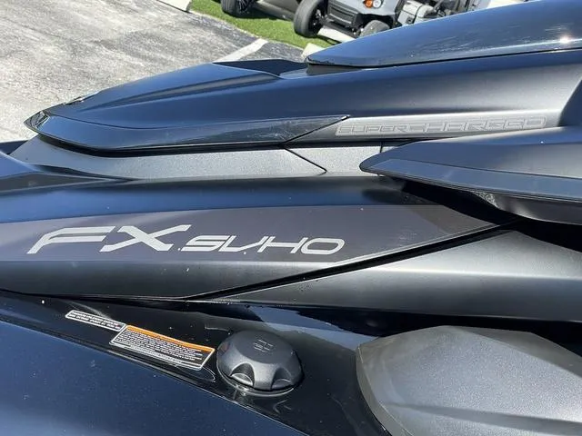 Slide: The Image of 2024 Yamaha Waverunner FX SVHO, supercharged, sleek black design, close-up view. - 10