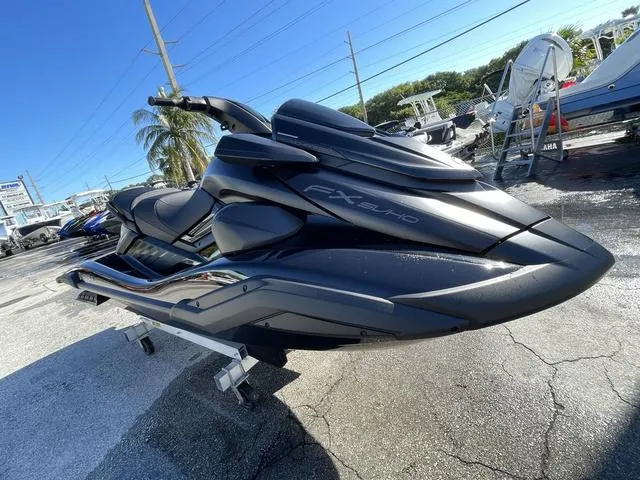Slide: The Image of 2024 Yamaha Waverunner FX SVHO® jet ski on display, sleek black design, outdoor setting. - 12