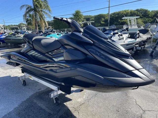 Slide: The Image of 2024 Yamaha Waverunner FX SVHO® jet ski in a showroom, sleek black design. - 4