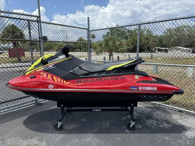 Slide: The Image of 2024 Yamaha WaveRunner EX in red and black, displayed outdoors on a stand. - 1