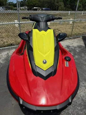 Slide: The Image of 2024 Yamaha WaveRunner EX in red and yellow, parked outdoors. - 3