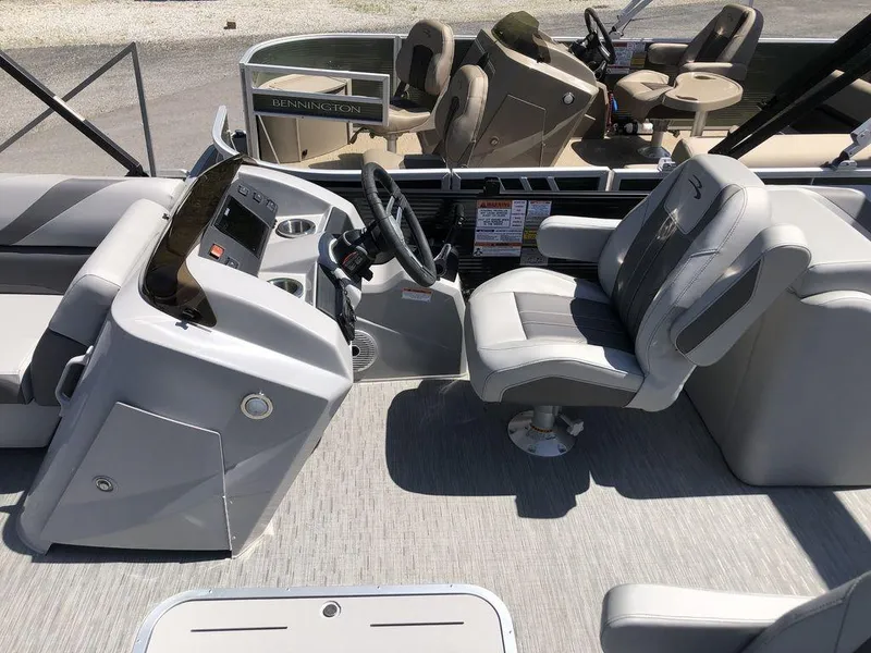 Slide: The Image of 2022 Bennington 22 SSRX boat interior with steering console and seating. - 4